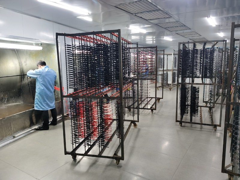 Frames on racks in the dust-free painting room. Photograph from the Jiayu factory pages.